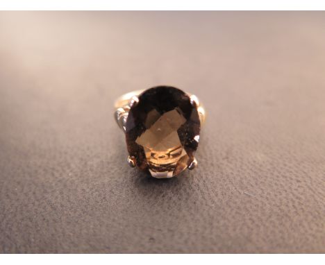 A 9ct yellow gold and oval cut smoked quartz dress ring size K - approx weight 3.8 grams - surface scratches, light usage wea