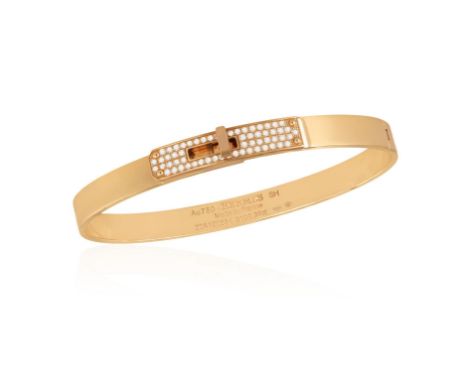 AN 18K GOLD AND DIAMOND 'KELLY BRACELET' BY HERMÈSThe polished gold oval bangle with 'Kelly' turn-clasp pavé-set with brillia