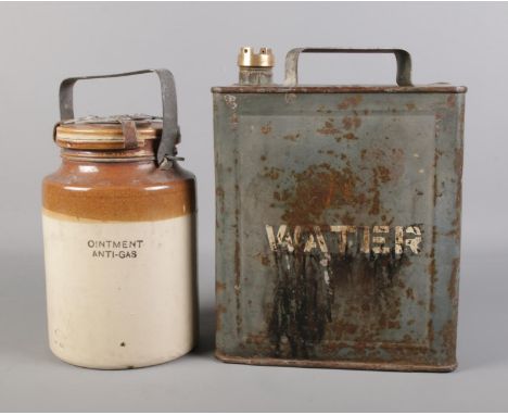 A WW2 military stoneware gas ointment jar with military can. Can is stamped 1955 with W D and broad arrow. Can H: 32cm.  Jar 