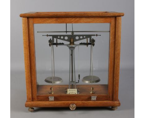 A cased set of chemical scales by Philip Harris Ltd. Birmingham.  Crack to the glass on the back left corner.