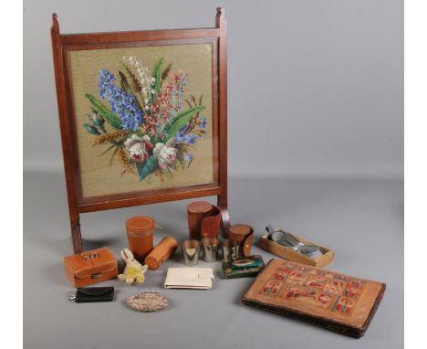 A box of collectables and tapestry fire guard. To include a leather clutch bag with Egyptian design , a leather bound glass, 