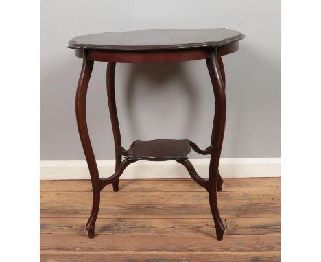 An early 20th century Mahogany window table, on tapering legs united with under shelf.  