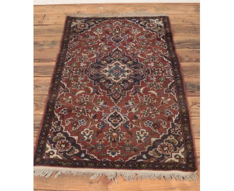A Keshan rug. With central medallion design on a blue and light brown ground. 137 x 82cm.  