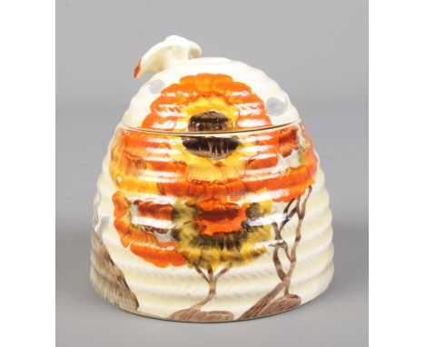 A Wilkinson Ltd Clarice Cliff beehive honey pot decorated in the Rhodanthe design. 10cm.  