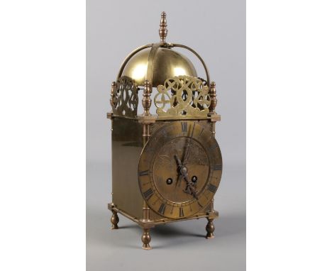 A vintage brass lantern clock with French movement.  