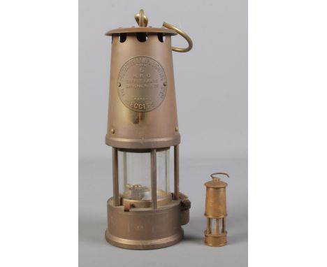 An Eccles Type 6 miners safety lamp, produced by The Protector Lamp &amp; Lighting Co Ltd. To include a miniature brass lamp.