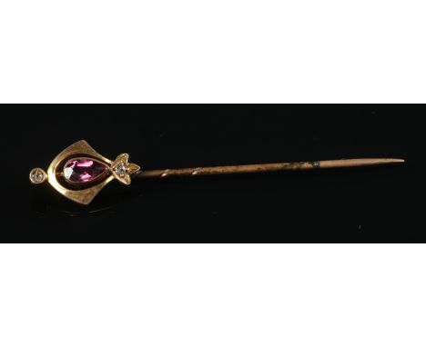 A 15ct gold stick pin with central Ruby stone and two diamonds. Total Length: 5.5cm. Total weight: 1.56g.  Pin comes in origi