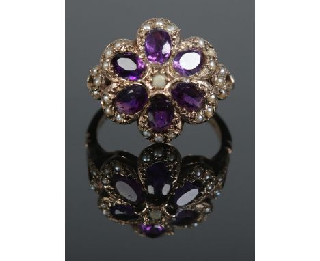 A vintage 9ct gold amethyst and seed pearl floriform ring. Assayed London 1974. Size R. 5.85g.  