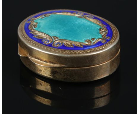 A continental silver gilt pill box with central guilloche enamel panel. Stamped 800. 21g.  