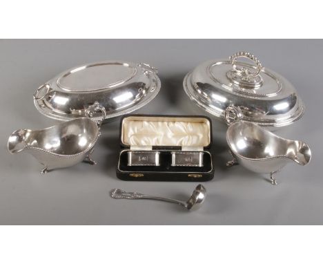 A collection of silver plate. Includes tureens, pair of sauce boats, cased napkin rings and a small ladle.  