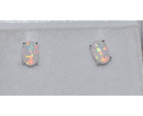 A pair of silver and opal ear studs