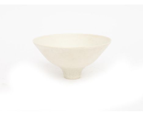 Lucie Rie (1902-1995) A white glazed porcelain bowl with incised bands of lines, to the inside as well as alongside the base 
