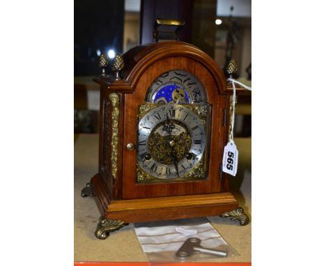 A JOHN THOMAS OF LONDON MOON PHASE MANTLE CLOCK, the silvered dial having Roman numerals bordered by gilt spandrels, the maho