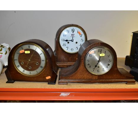 THREE FIRST HALF 20TH CENTURY OAK CASED DOME TOPPED MANTEL CLOCKS, comprising a Smiths three train chime / silent mantel cloc