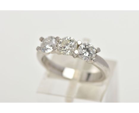 A PLATINUM THREE STONE DIAMOND RING, designed with three round brilliant cut diamonds in a four claw shared setting, colour a