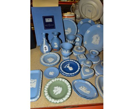 A GROUP OF WEDGWOOD JASPERWARE, mainly pale blue including bud vases, small urn shaped vases, a table clock, a pair of candle