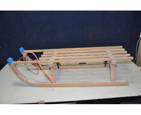 A PILZ DAVOS MODERN WOODEN SLED with metal runners, length 100cm