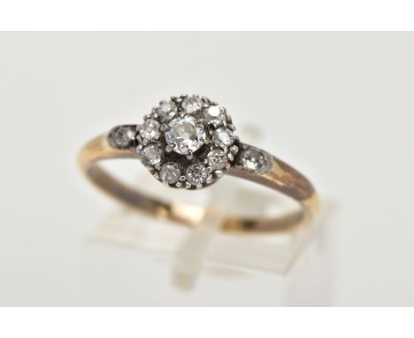 A YELLOW METAL DIAMOND CLUSTER RING, of a circular design, slightly tiered cluster set with old cut diamonds, old cut diamond