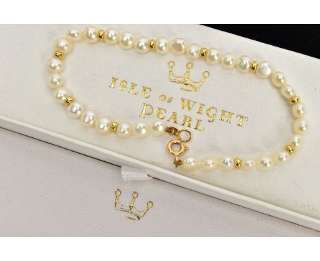 A CULTURED PEARL BRACELET, cultured white button pearls every three pearls interspaced with a yellow metal spacer, each pearl