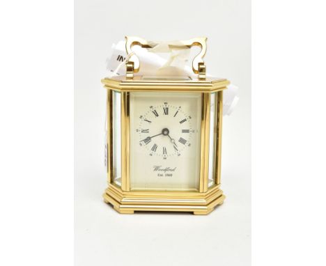 A WOODFORD BRASS MECHANICAL CARRIAGE CLOCK, hexagonal shape, white dial signed 'Woodford Est.1860', Roman numerals, approxima