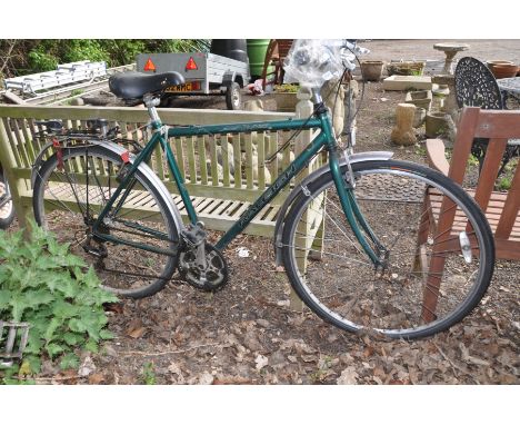 A GREEN RALEIGH PIONEER GENTLEMANS BICYCLE, with a 21   frame, shimano gears and a rear luggage rack