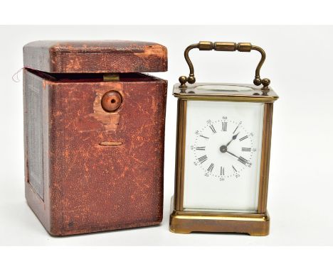 A CASED BRASS CARRIAGE CLOCK, white dial with Roman numerals and an outer Arabic minutes dial, working condition although tim