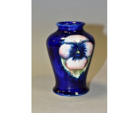 A MOORCROFT POTTERY SMALL BALUSTER VASE DECORATED WITH A PANSY DESIGN ON A BLUE GROUND, impressed marks including facsimile s