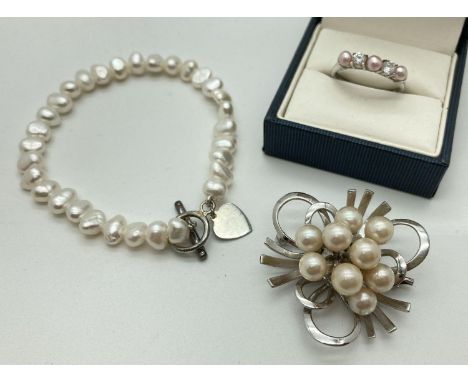 3 items of silver and pearl jewellery. A vintage floral spray brooch, a freshwater pearl bracelet with T-Bar clasp and heart 