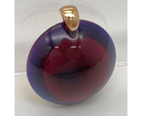 A Baccarat crystal circular shaped dome topped pendantif with 18ct gold bale. In deep red with metallic backing which shows b