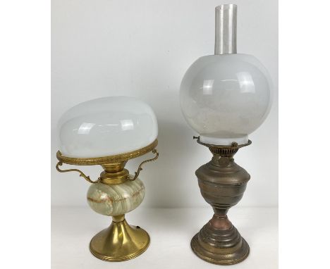 A vintage brass oil lamp with glass chimney and shade, together with a brass and green onyx desk lamp with white glass lamp s