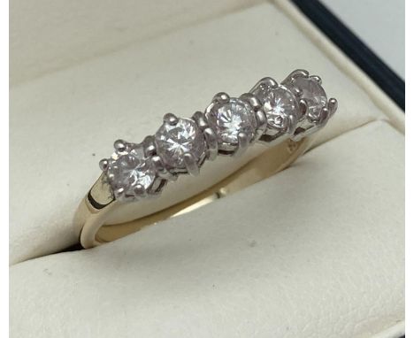 A Gold on silver half eternity ring set with 5 round cut clear stones. Inside of band marked 925. Ring size P. 