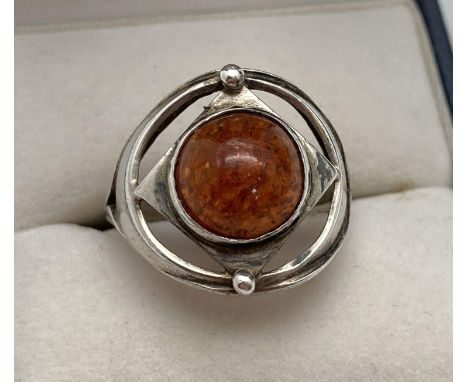 An Arts &amp; Crafts design silver and amber dress ring. Fully hallmarked with Birmingham assay mark inside band. Ring size M