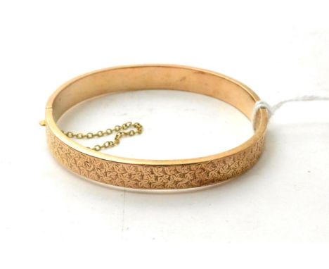 A 9ct gold foliate engraved bangle 8.66g gross 