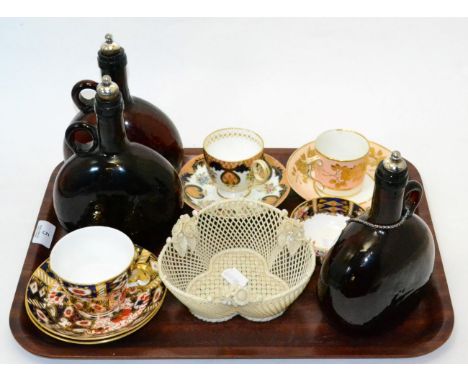 Early Belleek trefoil basket, three Victorian amber glass carafes and four cabinet cups and saucers 