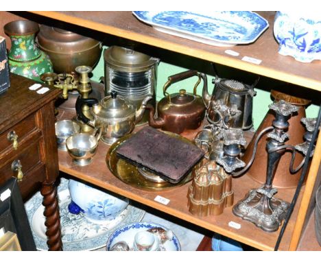 A shelf of assorted metalwares including copper jelly moulds 