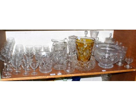 A shelf of cut glass, drinking glasses, jugs, vases, decanters, etc