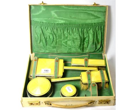 Silver and yellow enamel travelling dressing table set, cased 