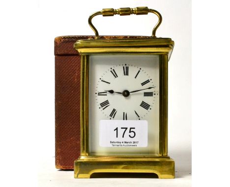 A brass carriage clock with carrying case