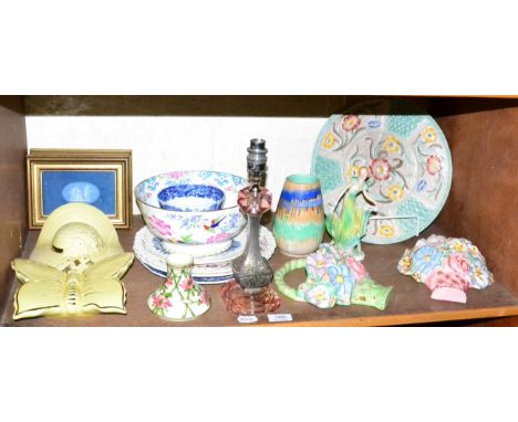 A shelf of Art Deco and 20th century ceramics including wall pockets and a table lamp