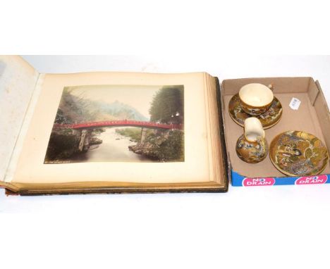 A 19th century Japanese satsuma teacup , two saucers and a milk jug (a.f.) together with a Japanese lacquered photograph albu