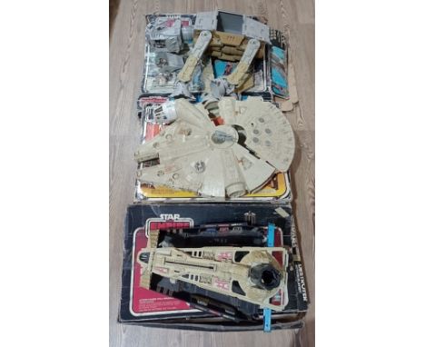 3 vintage star wars toys to include a Millennium Falcon, Darth Vader's Star Destroyer and an AT-AT, all with original boxes.