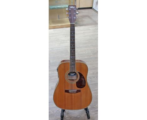 A 'Vintage' electro acoustic guitar with soft case. 