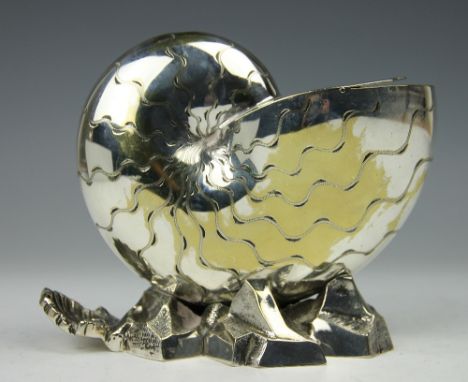 A silver plated spoon warmer, designed as a nautical shell upon a rocky base, with a scallop shell moulded handle and hinged 