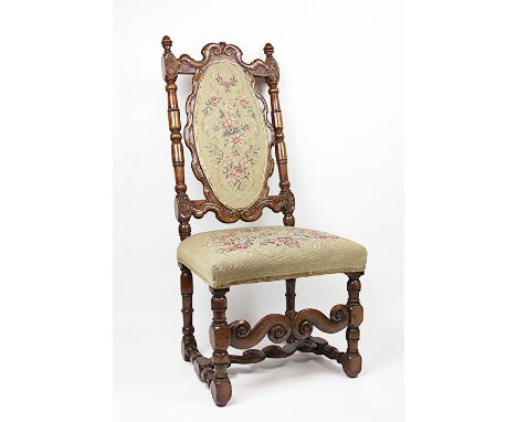 A late 17th century carved walnut side chair, with oval panel back and tapestry seat, on turned and block legs, 121cm