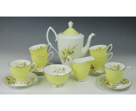 A Royal Albert Primrose decorated coffee service, each  with yellow glazed exterior, comprising coffee pot and cover, six cof