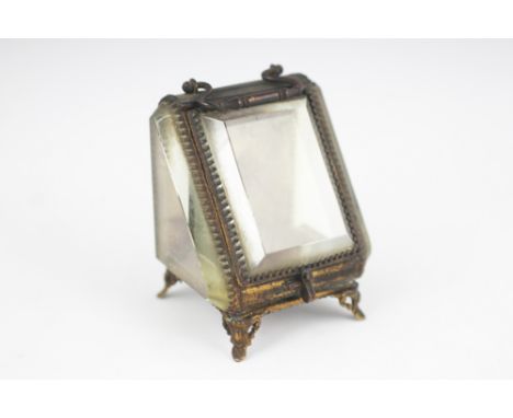A Victorian gilt metal mounted fob watch casket, the canted front enclosing a button silk interior, bevelled glass to three s