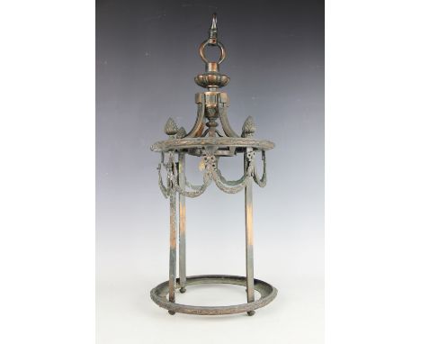 A late 19th century copper hall lantern, of cylindrical form and mounted with bow tied hair bell swags, no glass, 56cmLightin