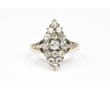 A Victorian diamond set ring, the marquise shaped panel, set throughout with old cut diamonds, claw set in white metal to the