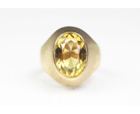 A citrine set ring, 'S&Co' London 1979, set with a central oval citrine within a plain polished tapering setting, size R/S, w