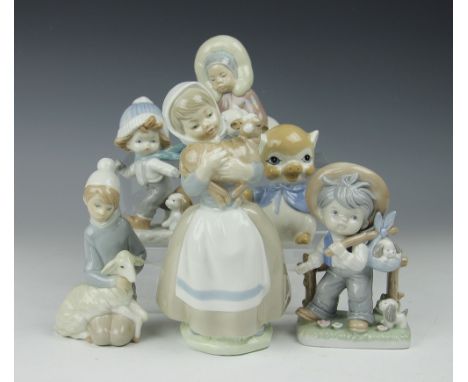 A Lladro figure of a boy shepherd, 15cm high, and another of a child Eskimo and Polar Bear, 13cm high, along with a Nao figur